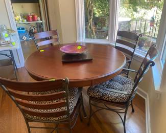 Better pic of the glass and wood table. There are six matching chairs and seat cushions. 