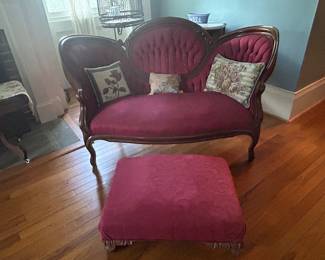 19th Century Red Velvet Victorian Settee with a walnut carved frame, medalion and tufted center back, and French feet