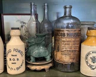 Early pottery beer bottles, French oil bottles, carved soapstone dragon