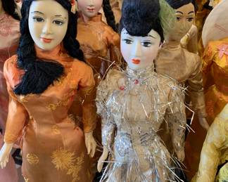 Loads of 1960s Vietnamese Dolls in a rainbow hued variety of ensembles 