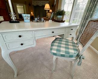Distressed Painted French Country Desk. Painted white with fine blue outlining. 5 drawer with same style chair with caning and painting on both back and seat. Comfortable seat cushion included. 
