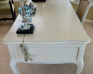 Distressed Painted French Country Desk. Painted white with fine blue outlining. 5 drawer with same style chair with caning and painting on both back and seat. Comfortable seat cushion included. 
