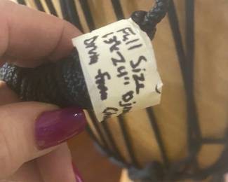 UP CLOSE OF THE AFRICAN DRUM TAG SHOWING IT'S SIZE
