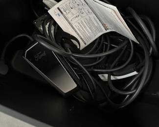 Level 2 EV charger. This one is labeled for a Ford but they are universal. Any EV but a Tesla can use this charger. You would need an adapter to use it with a Tesla.