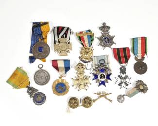 COLLECTION OF BADGES, AWARDS OF MERIT, ETC. | Including three 19th century enameled maltese crosses including Merenti 1866, Union Fait la Force; plus four French and French Canadian; Frontenac Club de Sports, Republique Francaise, Oublier Jamais!; A Silver "Safe and Sane 4th of July 1911" medal (21.4g), a "Les Veterans Des Armees de Terre et de Mer" medal, a (probably) silver Joan of Arc 1920's award with sunflower pin; plus several other pins and awards.

