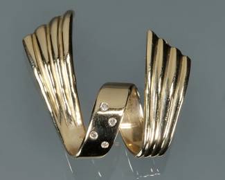 DIAMOND & 14K GOLD SPIRAL MOUNTING | Four melee diamonds set in a 14k yellow gold spiral ribbon-form mounting, with fineness mark; 1.5 in, 5.6g.
