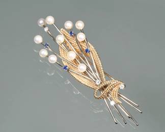 PEARL, SAPPHIRE, DIAMOND, & 14K GOLD BROOCH | Designed as 14 karat white gold sprays mounting 11 round pearls for small sapphires and four melee diamonds within a twisted rope pattern yellow gold surround; 3.25 in., 20.4 g.; marked "14k"
