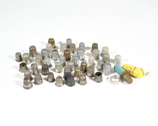 COLLECTION STERLING & OTHER THIMBLES
 | A collection of antique and later thimbles, including five sterling silver thimbles with fineness marks (together 0.62 ozt), and many unmarked thimbles, including some decorated with enamel and several with engraved decoration, including one antique thimble with engraved townscape and monogram
