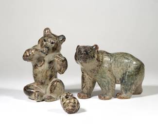 (3pc) KNUD KYHN ROYAL COPENHAGEN BEARS | Mid-century glazed porcelain bear figures by Knud Kyhn for Royal Copenhagen, Denmark, including a bear standing on all fours, no. 20155 (l. 6.75 in.), a seated bear, no. 21675 (h. 7 in.), and a small bear cub (l. 1.75 in.), all with Royal Copenhagen marks and/or labels, the latter two with incised initials "KK".
