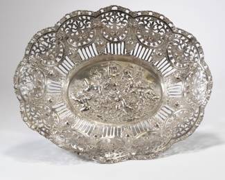 CONTINENTAL SILVER OPENWORK BASKET | 800 silver basket / tray of large size with intricate reticulated rim and repousse scene of putti in center; 32.4 ozt - l. 17.5 x w. 14.75 x h. 3.5 in.

