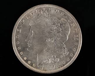 1887-P MORGAN SILVER DOLLAR | In a folding envelope describing it as "borderline MS 65"