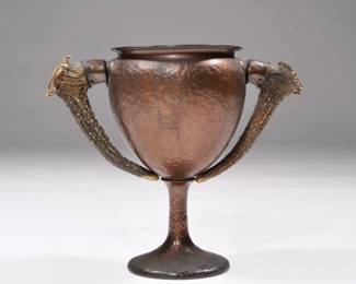 JOHN FRICK, NY HAMMERED COPPER ARTS & CRAFTS TROPHY CUP | Designed as large hammered copper goblet mounting two antler handles - w. 10.5 x h. 8.5 in.