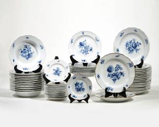 (50pc) MEISSEN BLUE FLOWER CHINA SERVICE | In blue flower pattern with insects, comprising: nineteen 9.75-inch plates, two having gilt rims [one with chipped rim, one with crack to rim, and one gilt plate with crack]; twelve 9.25-inch low bowls [one with old through crack at rim]; seven 8.5-inch plates [one with long through crack]; and twelve saucers or bread and butters (plus one with a gilt rim) [one with repaired rim, one with flake to footrim] - l. 12.5 x w. 8.5 x h. 9.5 in. (tureen)
