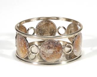 THOMAS MEISTER SILVER WINE COASTER | German 800 silver wine coaster inset with six 19th century coins, including German coins, U.S. coins, and a Persian coin, with fineness mark and maker's mark "TH. MEISTER" on bottom; 11.08 ozt - h. 1.875 x dia. 4.25 in.