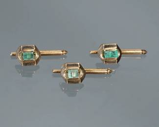 (3pc) EMERALD & 14K GOLD SHIRT STUDS | Three matching shirt studs, each having a central rectangular rough cut emerald (4 x 4 x 4 mm), the cross-section of the emerald appears hexagonal and may be "natural" growth; 1 inch (each) 6.7g total weight; tested to 14k.

