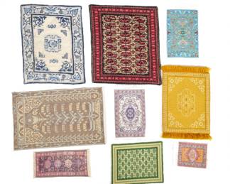 (9pc) DOLLHOUSE MINIATURE RUGS | Including a blue Chinese-style carpet (9-1/2 x 7 in.), a red overall pattern rug (9-1/2 x 8-1/4 in.), three small silk woven carpets with fringe, an Akstafa style runner with Keshishian Collection, San Clemente, CA label on verso (2-3/4 x 6 in.), and others.