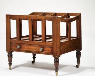 ANTIQUE WOOD CANTERBURY | Having four equal partitions with curved top over a full-width drawer with round brass pulls and cockbeading, raised on turned and fluted legs with brass casters.  - l. 21 x w. 16.25 x h. 19.5 in.

