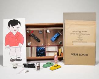 STANFORD-BINET COMPLETE TEST MATERIAL | By Lewis Terman and Maud A. Merrill, in a wooden fitted box - l. 15 x w. 10.5 x h. 3 in. (box)
