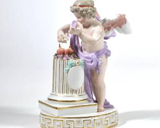MEISSEN PORCELAIN CUPID | Porcelain figure of Cupid with elixir of love, with underglaze blue crossed swords mark to bottom - l. 5.5 x w. 4 x h. 7.75 in.
