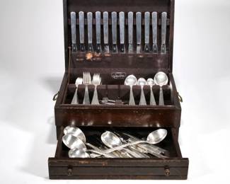 GERMAN 800 SILVER FLATWARE SERVICE | In a presentation box, comprising: 12 dinner forks, 12 lunch forks, 11 cake forks, 12 table spoons, 12 soup spoons, 24 demitasse spoons, 12 silver-handled dinner knives, 12 silver-handled lunch knives, 2 flat-handled butter spreaders, a sugar tong, a pair of salad servers, 4 serving spoons, a two-pronged serving fork, a cake server, and a two-piece silver-handled meat carving set; total weighable silver 138.39 ozt.