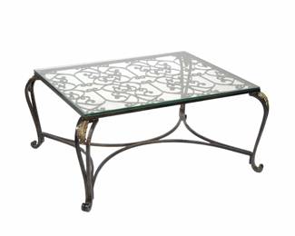 PIERRE DEUX LOW FORM COFFEE TABLE | Metal scrollwork with gilt highlights, glass top - l. 35 x w. 43 x h. 19 in.