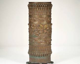 ORNATE BRASS STICK HOLDER/ UMBRELLA STAND | With repousse decoration of foliage patterns and putti between scenes separated by columns, raised on claw feet - h. 23 x dia. 8.5 in.