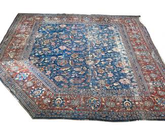ANTIQUE HERIZ/ SERAPI RUG | Floral overall pattern on a blue ground within a red border, cut and rearranged with a canted corner
 - l. 125 x w. 130 in.
