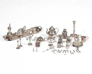 COLLECTION DOLLHOUSE MINIATURE FURNITURE | Dollhouse miniature silver, including sterling, comprising: a five piece English silver tea set with tea pot, coffee pot, open creamer, and open sugar on a long tray, each piece with Birmingham hallmarks and "A M & Co" maker's mark (all together 2.16 ozt); 15 other sterling silver items each with fineness mark, all stamped "MMA" except the pair of candlesticks (all together 4.56 ozt); an 800 silver double-handled box (0.2 ozt); three items with partial or indecipherable hallmarks, including a chair, teapot, and scalloped rim plate (together 0.6 ozt); and other silver-toned miniature items with no apparent hallmarks, including a candelabra, candlesticks, tankard, cup, salt and pepper, and a flatware set - l. 6 in. (tray)