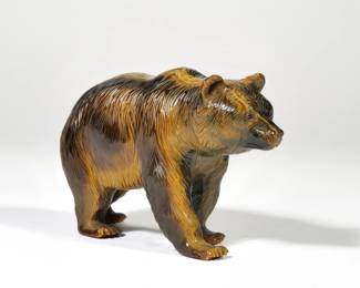 TIGER'S EYE CARVED BEAR | Finely carved tiger eye bear with red cabochon eyes, in the manner of Wedderien Inc., New York, with no apparent signature or label - l. 5.25 x w. 1.75 x h. 3.25 in.

