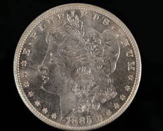1885-P MORGAN SILVER DOLLAR | Enclosed with a piece of paper describing it as "borderline MS65"