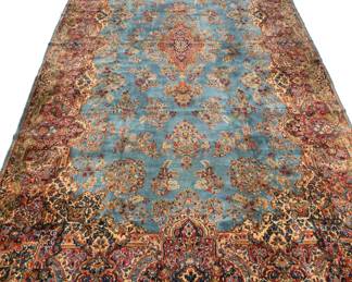 ANTIQUE SKY BLUE KIRMAN PERSIAN CARPET | Early 20th century, having a blue ground with beige, red, and green border, signed - l. 217 x w. 116 in.

