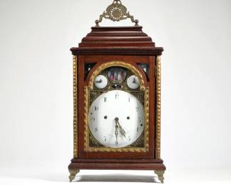 JOSEPH BRUMER SHELF CLOCK | Joseph Brumer, Vienna, 19th century, the enamel face with Arabic numerals and seconds dial, signed "Joseph Brumer / in Wein", set in pressed brass beneath a painted porcelain plaque depicting the crucifixion, in a carved and gilt case with glass sides and decorative brass mounts - l. 11.25 x w. 6.25 x h. 22 in.