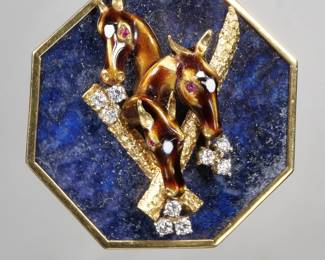 LAPIS, DIAMOND, ENAMEL & 18K GOLD PENDANT | An unusual pendant designed as an octagonal lapis set in an 18k gold surround, mounted by three enameled horse or giraffe heads, each with faceted ruby eyes, over two 18k gold branches with nine round diamonds, stamped 18K on the back; 35.9g
 - dia. 2-7/8 in. (excl. bail)