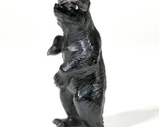 WEDDERIEN CARVED OBSIDIAN BEAR | Wedderien Inc., New York, finely carved obsidian bear in standing position, with Wedderien label on foot and signed with conjoined initials "WD" on opposite foot; accompanied by a newspaper clipping showing a picture of identical carving with the caption, "Obsidian bear worth $500" - l. 2.25 x w. 2 x h. 5.25 in.

