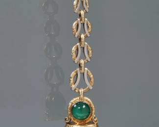 A CHALCEDONY CABOCHON & ENGRAVED 14K GOLD WATCH FOB | Designed as a pair of green chalcedony cabochons (each 11.5 mm diameter), mounted in a (tested to) 14k white and yellow gold letter-seal form watch fob with engraved links; no apparent makers mark or fineness marks; 3.5 in.;18.3g