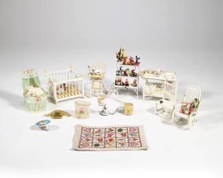 (12pc) DOLLHOUSE NURSERY ROOM MINIATURES | A collection of dollhouse miniature nursery room furniture and accessories, including: a crib with a baby, a fancy bassinet, a painted changing table with accessories, a rocking chair with pillows, a high chair with Peter Rabbit bowl and other objects, a needlepoint quilt (6.25 x 4.25 in.) and needlepoint sweater, a plant stand with flowers and toys, a wicker chair, a laundry hamper, wastebasket, Mother Goose painted step stool signed "ZELINA", and an electrified table lap - l. 3.25 x w. 3.25 x h. 2.75 in. (crib)