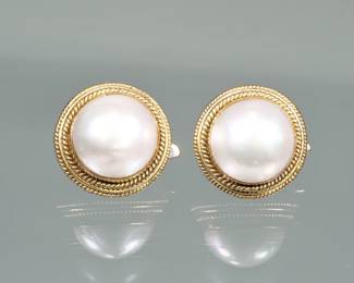 PAIR PEARL & 14K GOLD EARRINGS | Designed as central large half pearls (dia. 15mm) set in 14 karat gold surrounds with ear clips;  0.75 in., 14.6g total weight.

