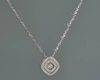 DIAMOND PENDANT NECKLACE | A single diamond nested inside two diamond-encrusted squares, on a chain.

