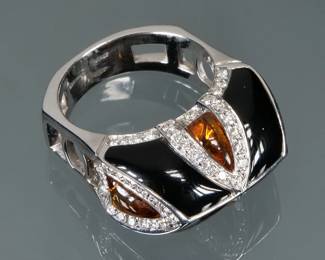 ENAMEL & AMBER 18K GOLD RING | Italian, designed as smoothed teardrop amber alternating with black enamel panels divided by sections of melee diamonds, marked inside the band, "Oro trend / 750 / Italy"; size 6.25, 11.5g 

