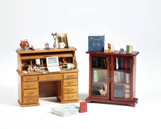 (2pc) MINIATURE OFFICE FURNITURE | Miniature dollhouse furniture, including a glass front bookcase cabinet filled with miniature books, some with tet pages, and a miniature rolltop desk covered in miniature accessories including a laptop, calendar, artist's palette, fish bowl, etc. - l. 5 x w. 1.75 x h. 4.5 in. (desk)