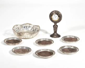MISC. SILVER OBJECTS | Including a set of six wood-lined sterling coasters, an openwork bowl marked "silver" (dia. 6 inn.), and a repousse silver desk clock with Arabic letter motif, tested as silver (h. 5.75 in.); weight of bowl 5.7 ozt