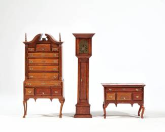 (3pc) DOLLHOUSE MINIATURE FURNITURE | Including a Chippendale style high boy and matching lowboy, both on cabriole legs with linenfold / fan drawer fronts and brass pulls, and a tall case clock with opening door revealing weights and pendulum; none appearing to be signed.  - l. 3.5 x w. 2 x h. 6.75 in. (highboy)