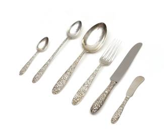 (85pc) STIEFF CHRYSANTHEMUM STERLING FLATWARE | Partial sterling silver flatware service in the Chrysanthemum pattern, comprising: 12 luncheon forks, 3 spoon / forks, a cocktail fork, 6 table spoons, 12 iced tea spoons, 12 demitasse spoons, 12 silver-handled luncheon knives, 12 flat-handled butter spreaders, a jelly spoon, a small jelly spoon, a large silver-handled fish server, a two-piece fish serving set, a silver-handled serving fork, 2 silver-handled cake servers, a two-piece silver-handled meat carving set, a pair of sugar tongs, and 4 other serving pieces; total weighable silver 76.33 ozt.
