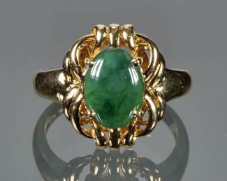 JADEITE CABOCHON & 18K GOLD RING | Designed as a central jade cabochon (10 x 7.4 in.) With gold backing in an 18 karat gold open works surround and ring; size 6.5, 6.5g.