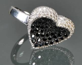 BLACK DIAMOND & 18K WHITE GOLD RING | Black diamond encrusted heart surrounded by melee diamonds, all set in 18k white gold, with fineness mark inside the band; size 5.5, 8.0g.

