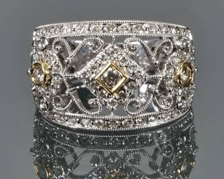 DIAMOND & 18K GOLD FILIGREE RING | Designed as three .15ct diamonds set in yellow gold bezels among and lines of melee diamonds in a filigree open work gallery; size 5.75, 6.9g; interior marked "750"