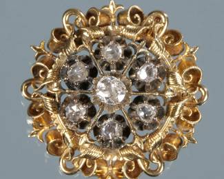 ANTIQUE FLOWER HEAD BROOCH | Designed as a round gold openwork gallery with engraved scrolls, ropework, and fleur-de-lis, the center mounting six rose cut diamonds and a central .5 ct old mine cut diamond (5.1 x 4.7 x 2.4 mm); 17.4g  - dia. 1.5 in.

