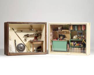 (2pc) MINIATURE DOLLHOUSE DIORAMAS | Two dollhouse miniature shadow box dioramas, including a sewing room / seamstress shop with bolts of fabrics, sewing machine, dress form, miniature buttons and spools of thread, and other sewing accoutrement, and a medieval themed workshop / storage room with lace dress, keys, dresser items, weapons, etc. - l. 9.5 x w. 3 x h. 7.5 in. (sewing room case)