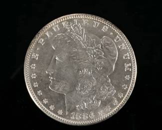 1886-P MORGAN SILVER DOLLAR | In a folding envelope describing it as "borderline MS 65".