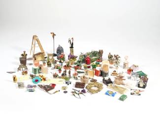COLLECTION DOLLHOUSE MINIATURES | A collection of miniature dollhouse accessories and decorative objects, including a brass log holder, gilt style mirror, wall clock, miniature woven baskets (one with tools), a typewriter, fire extinguisher, books, packaged goods, a ladder, flowers and plants, a koi pond, etc. - l. 4.5 in. (pond)
